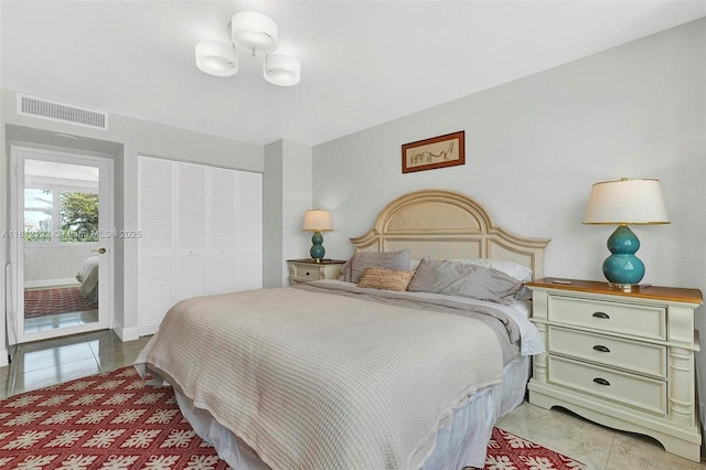 tiled bedroom featuring a closet