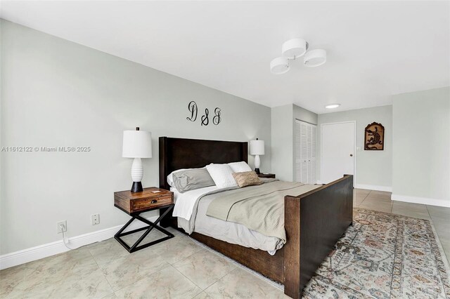 bedroom featuring light tile patterned floors and a closet