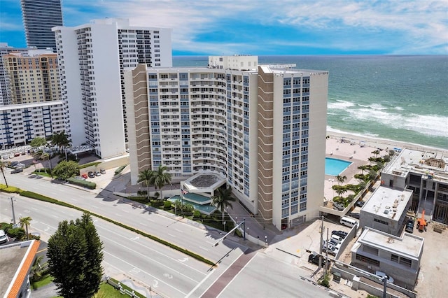 view of building exterior with a water view and a view of the beach