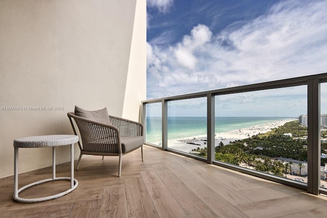 balcony with a beach view and a water view