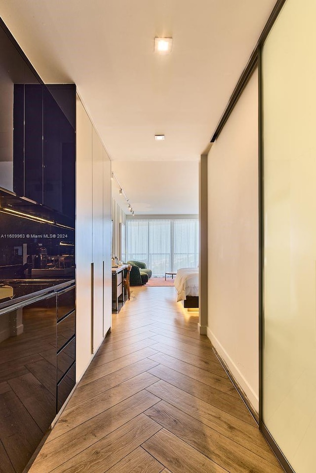 hallway with expansive windows and rail lighting