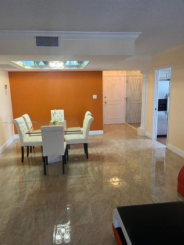 tiled dining area featuring crown molding and a textured ceiling