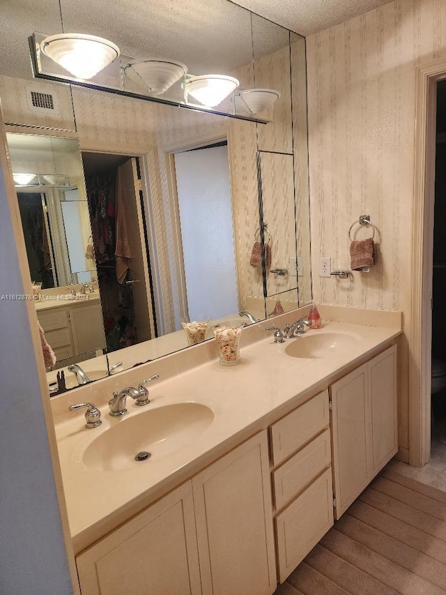 bathroom featuring double vanity and hardwood / wood-style flooring