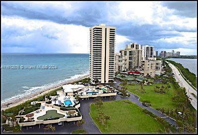 drone / aerial view with a beach view and a water view