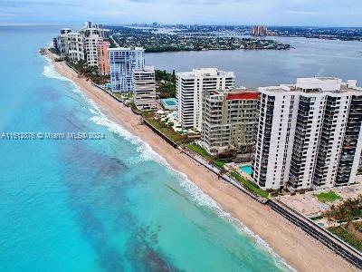 aerial view with a water view and a beach view