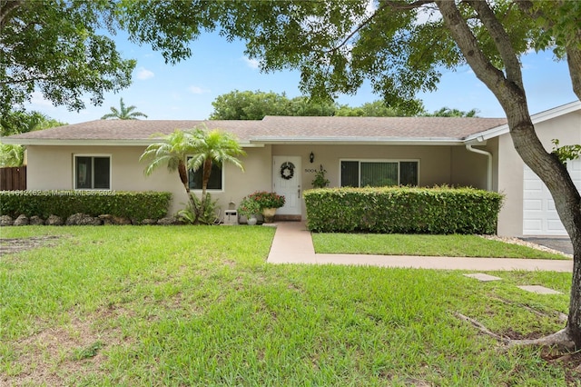 ranch-style home featuring a front yard and a garage