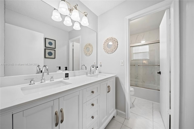 full bathroom featuring vanity, shower / bath combination with glass door, tile patterned floors, toilet, and a textured ceiling