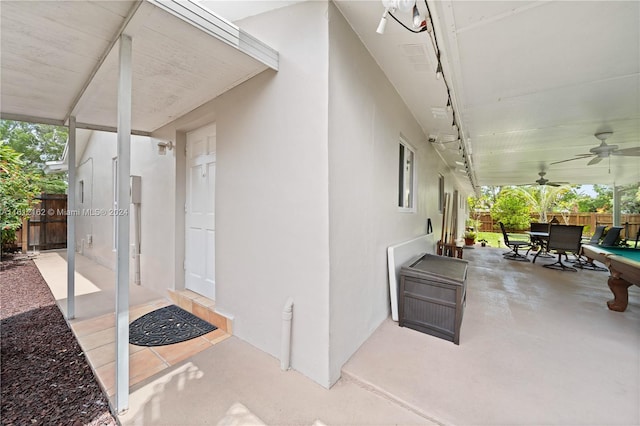 doorway to property with ceiling fan and a patio