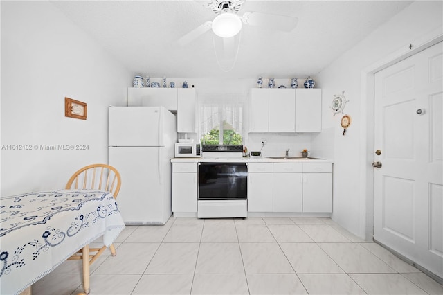 kitchen with white appliances, ceiling fan, sink, light tile patterned floors, and white cabinetry