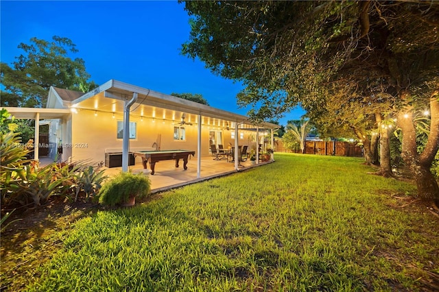 back of house with a patio area and a lawn