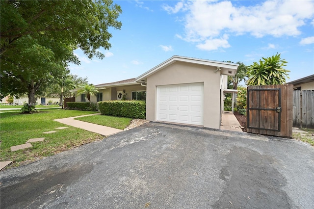 ranch-style home with a front yard and a garage