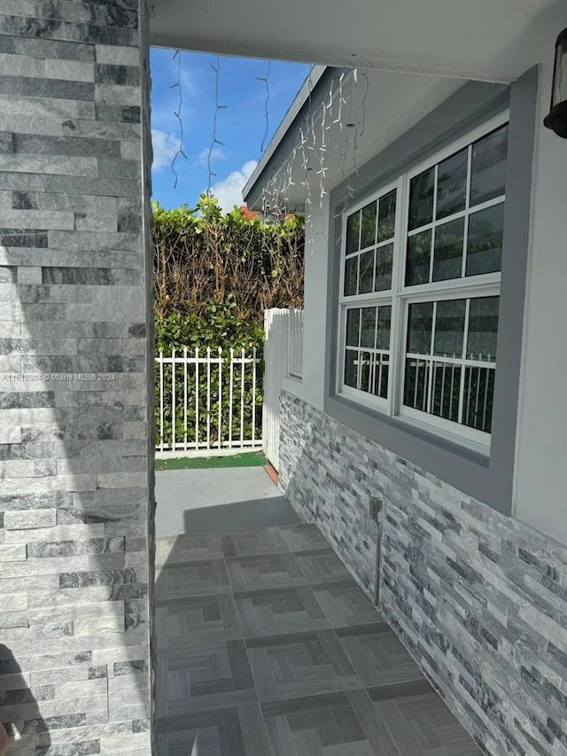 view of home's exterior with a patio area and fence