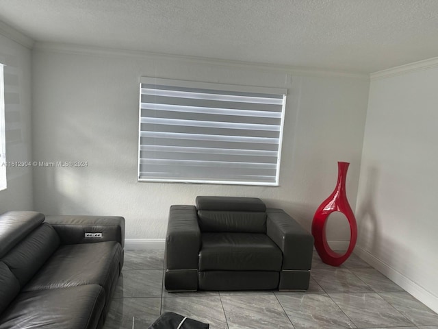 living room with crown molding, a textured ceiling, and baseboards