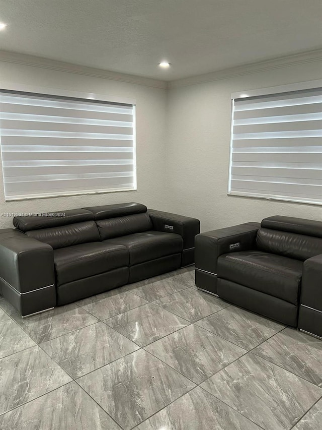 living area with marble finish floor and crown molding