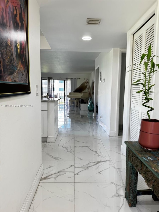 corridor with light tile floors