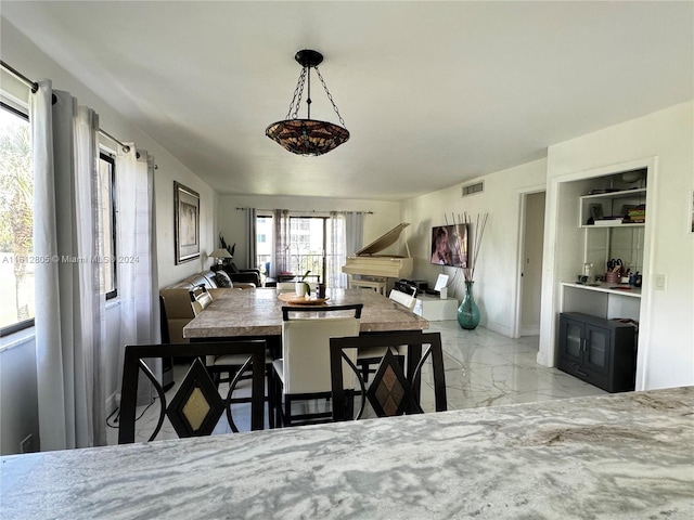 dining space with light tile floors