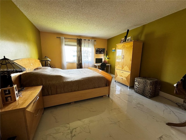 bedroom with tile flooring and a textured ceiling