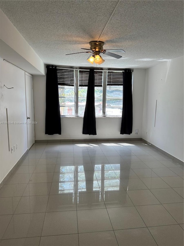 unfurnished room featuring ceiling fan and light tile patterned flooring