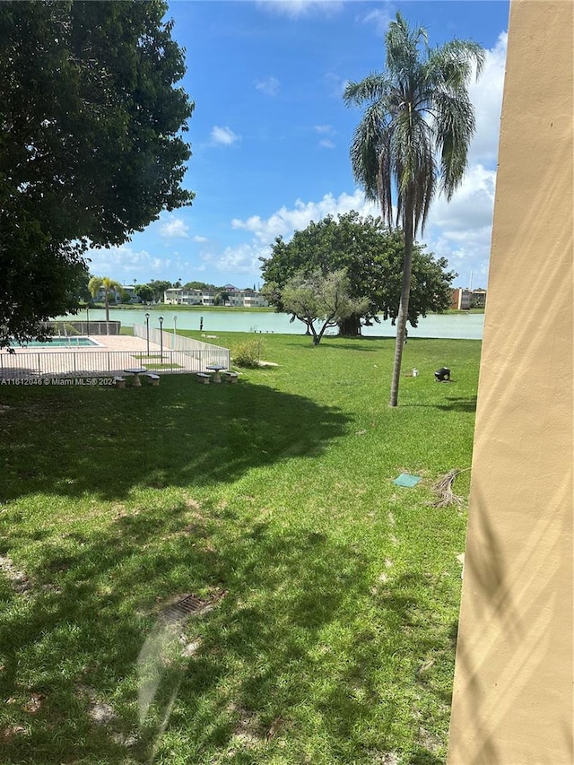 view of yard featuring a water view and a community pool