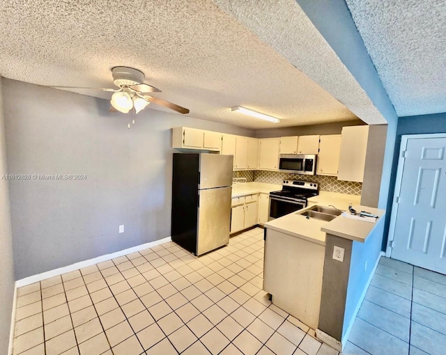 kitchen featuring a textured ceiling, ceiling fan, stainless steel appliances, and white cabinets