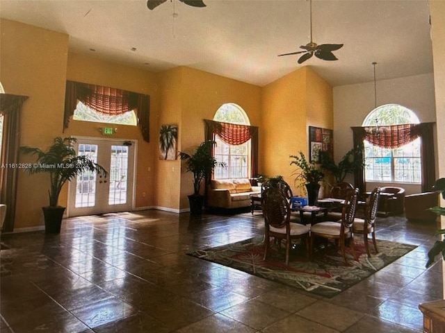 dining room with ceiling fan, french doors, and high vaulted ceiling