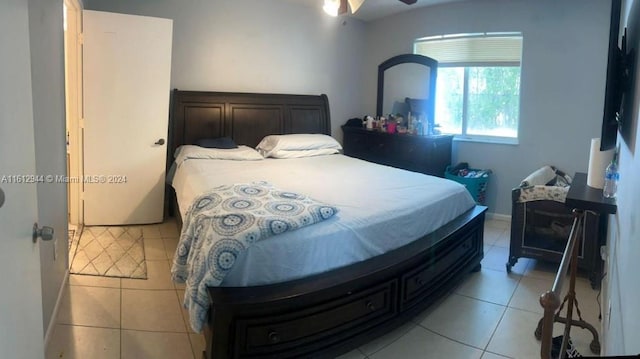 tiled bedroom featuring ceiling fan