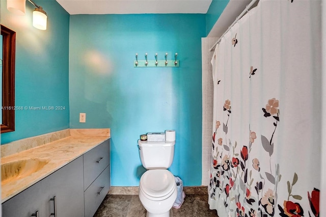 bathroom with tile patterned flooring, vanity, and toilet