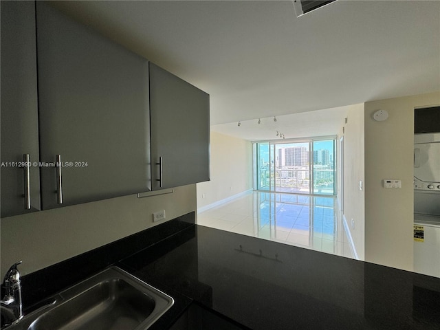 kitchen with gray cabinetry, sink, and light tile floors