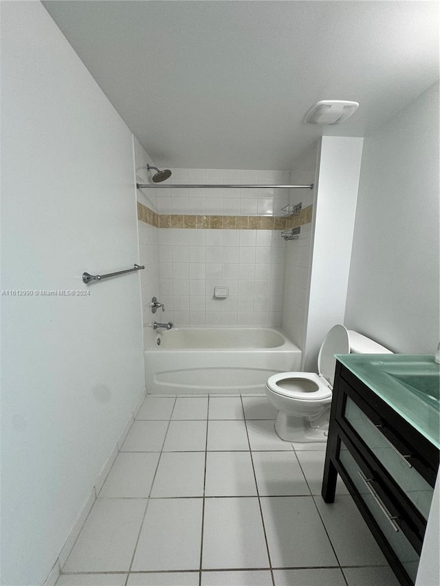 full bathroom featuring tile flooring, vanity, toilet, and tiled shower / bath combo