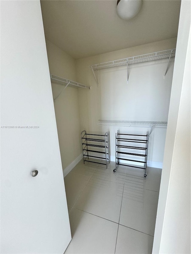 spacious closet with tile floors