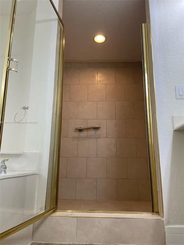 bathroom with a shower with door