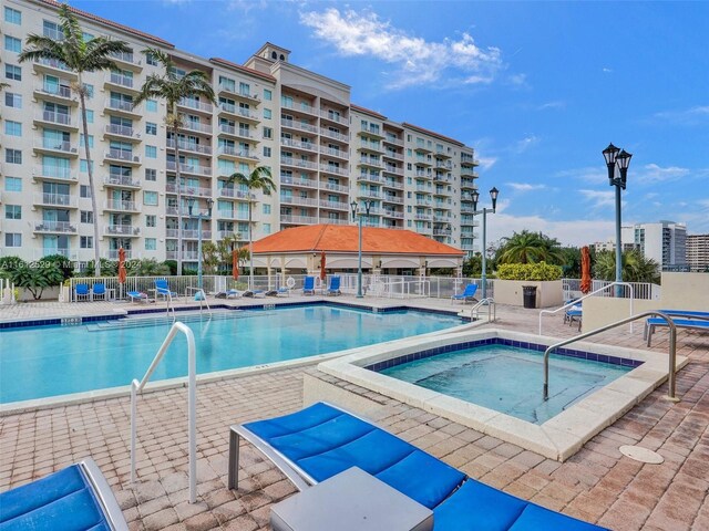 view of pool featuring a patio and a hot tub