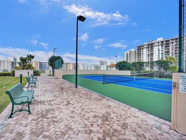 view of home's community featuring tennis court