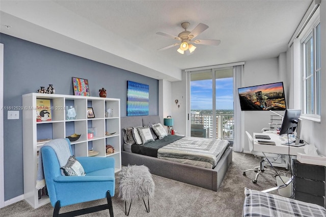 bedroom with ceiling fan, access to exterior, carpet floors, and a textured ceiling