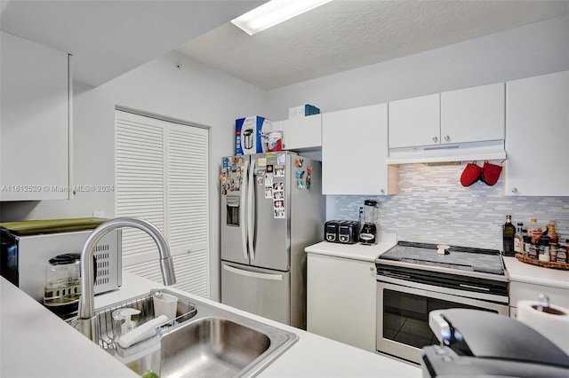 kitchen featuring backsplash, white cabinets, sink, a textured ceiling, and appliances with stainless steel finishes