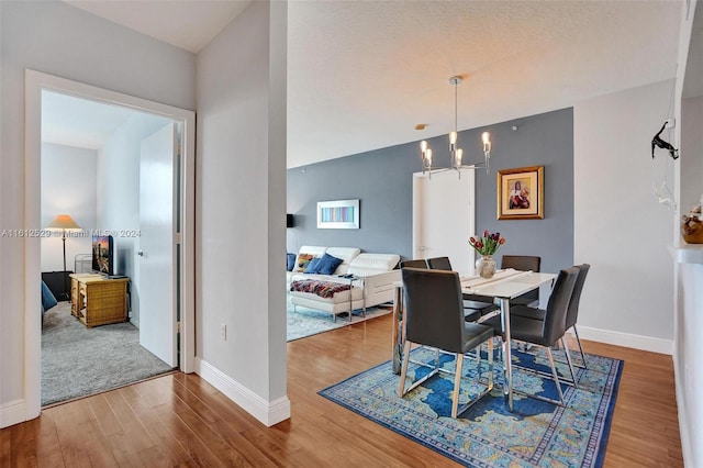 dining area featuring hardwood / wood-style floors and a notable chandelier