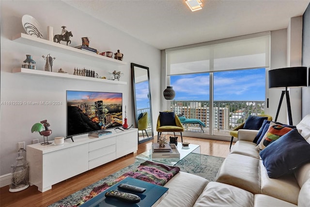 living room with hardwood / wood-style floors, a textured ceiling, and expansive windows