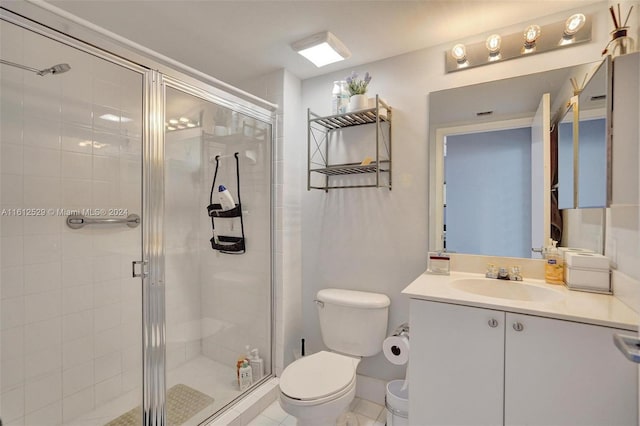 bathroom with tile patterned flooring, vanity, toilet, and an enclosed shower