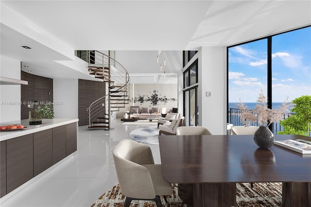 dining space with floor to ceiling windows and light tile patterned floors