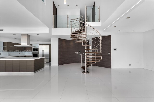 stairs with tile patterned flooring and sink