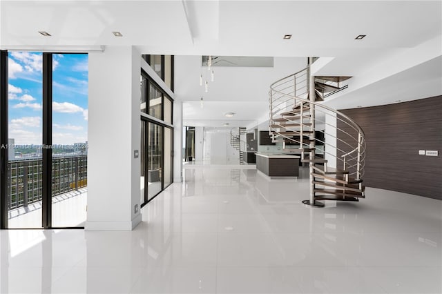 hall featuring expansive windows and light tile patterned floors