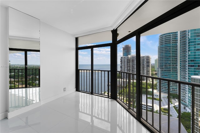 sunroom with a water view and a healthy amount of sunlight