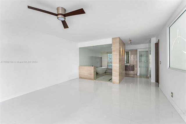 unfurnished room featuring ceiling fan and tile patterned flooring