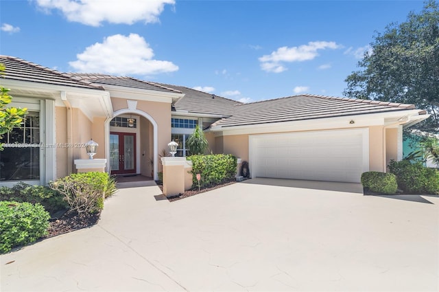 view of front of home featuring a garage and french doors