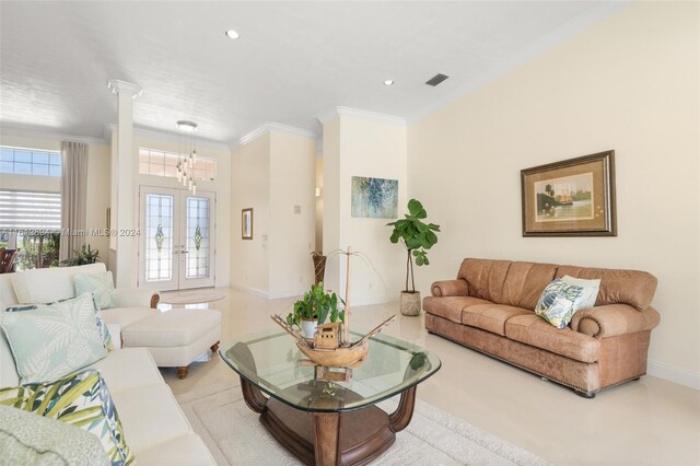 living room featuring a chandelier, decorative columns, french doors, and crown molding