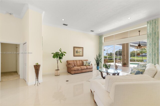 living room with tile floors, ornamental molding, and ceiling fan