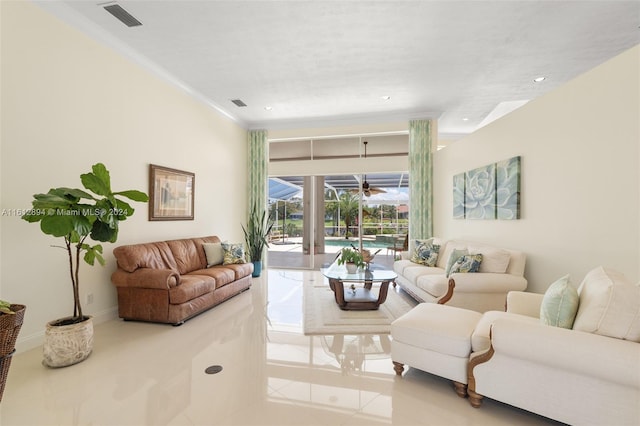 living room featuring tile floors and crown molding