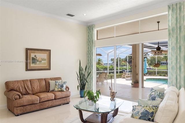 living room with ceiling fan and ornamental molding