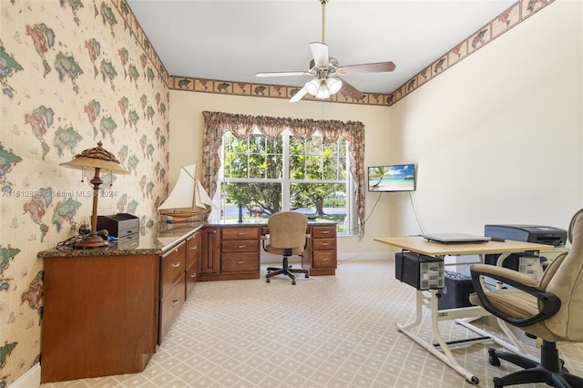 carpeted office featuring ceiling fan