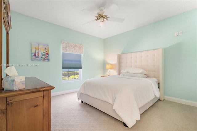 bedroom featuring ceiling fan and light carpet